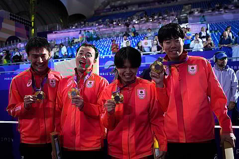 Fencers Kyosuke Matsuyama, Kazuki Iimura, Takahiro Shikine and udai Nagano celebrate after winning the gold medal